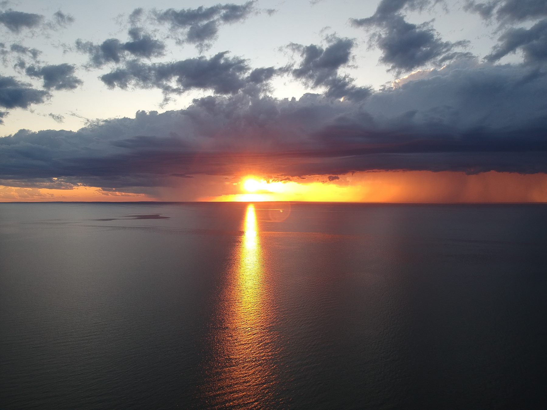 Sunset reflected as a bright path across dark water